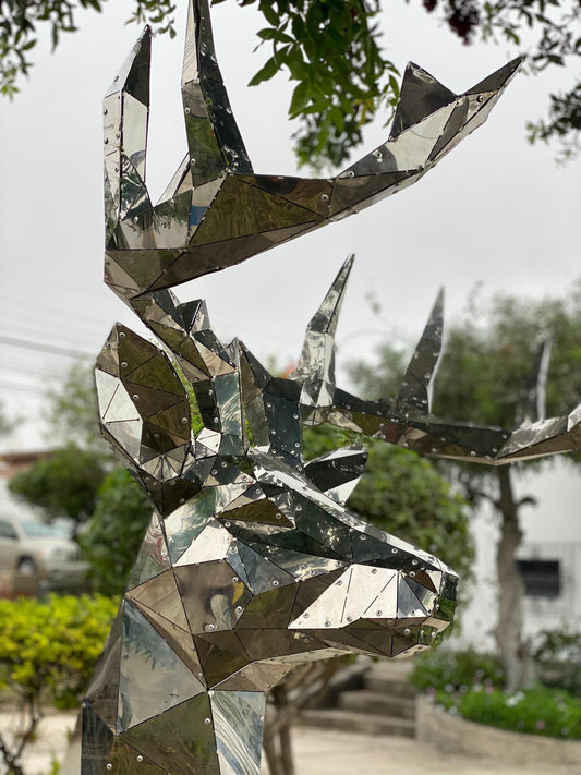 Finished low poly deer head sculpture in mirrored stainless steel with visible rivets, built from a DXF template