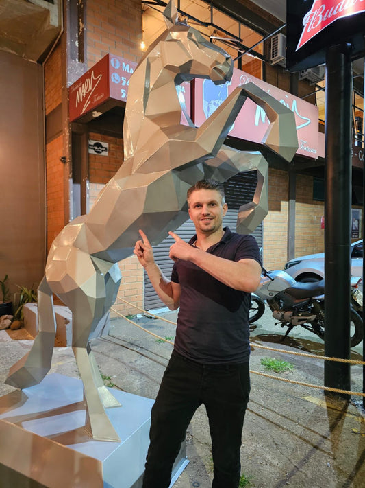 Large low poly rearing horse sculpture outside a shop in Brazil, a person standing beside it for scale, built in heavy welded sheet steel